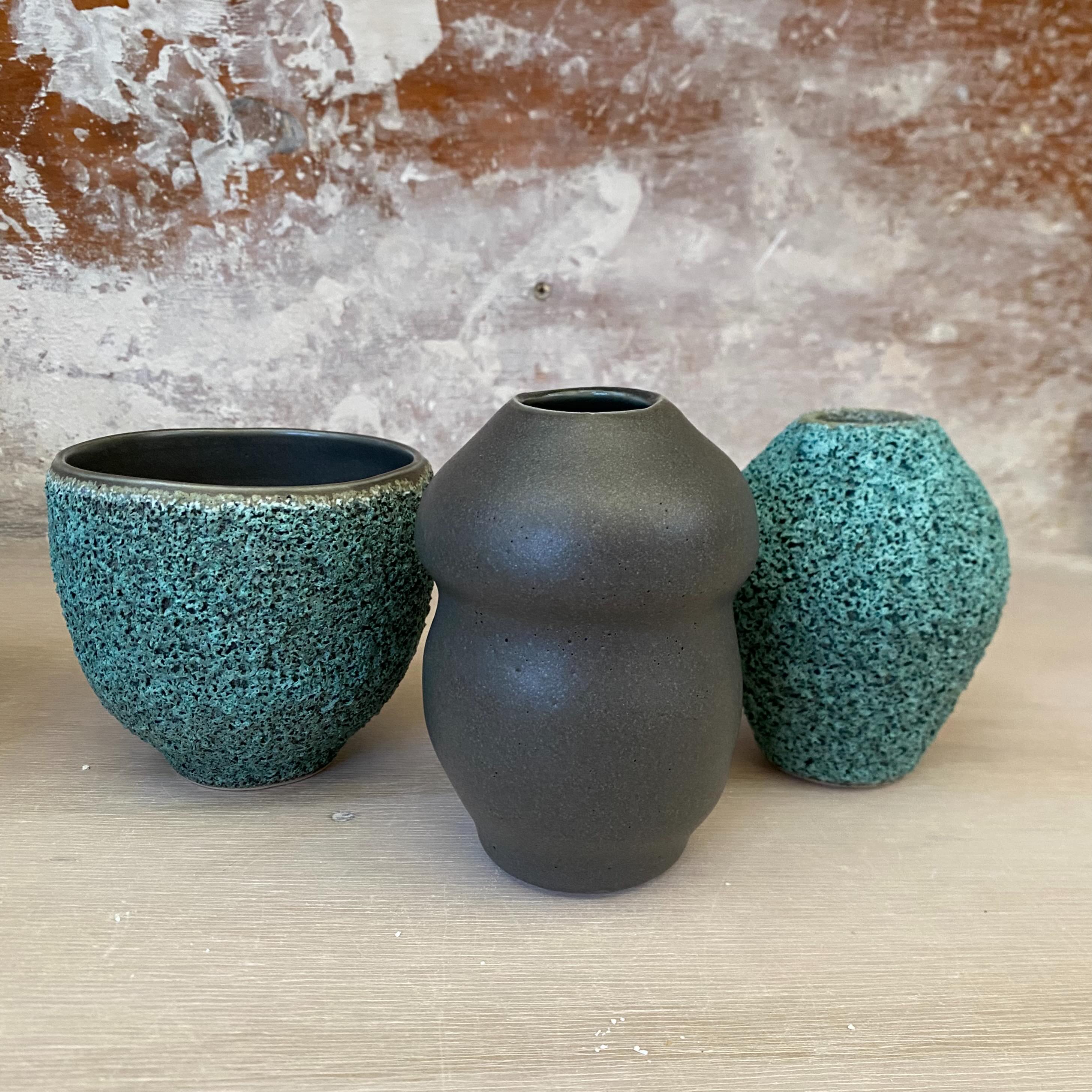 Group of pots with satin matt and lichen effect glazes.