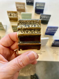 People keep asking me for recipes for cone 6 (1220°C). It’s not difficult to convert a glaze recipe from high temperature cone 10 (1300°C) to mid temperature; you just need to add around 5% frit to lower the temperature by one cone.

These are oilspot glazes fired at various studios around Australia, the UK and Europe. The original recipe was a Michael Bailey cone 10 oilspot glaze containing 5% frit. To fire it to cone 8, I added another 5% frit. For oilspots the viscosity of the molten glaze is very important. It needs to be viscous enough to hold the gas bubbles, allowing the glaze to smooth out but not run. The oxygen gas comes from thermal decomposition of red iron oxide in the glaze to black iron oxide. These were fired in oxidation in electric kilns.

The best way to convert a glaze to fire at lower temperature is to add 5,10,15,20% frit in a series of glaze tests known as a line blend and see which one works best at your kiln temperature.