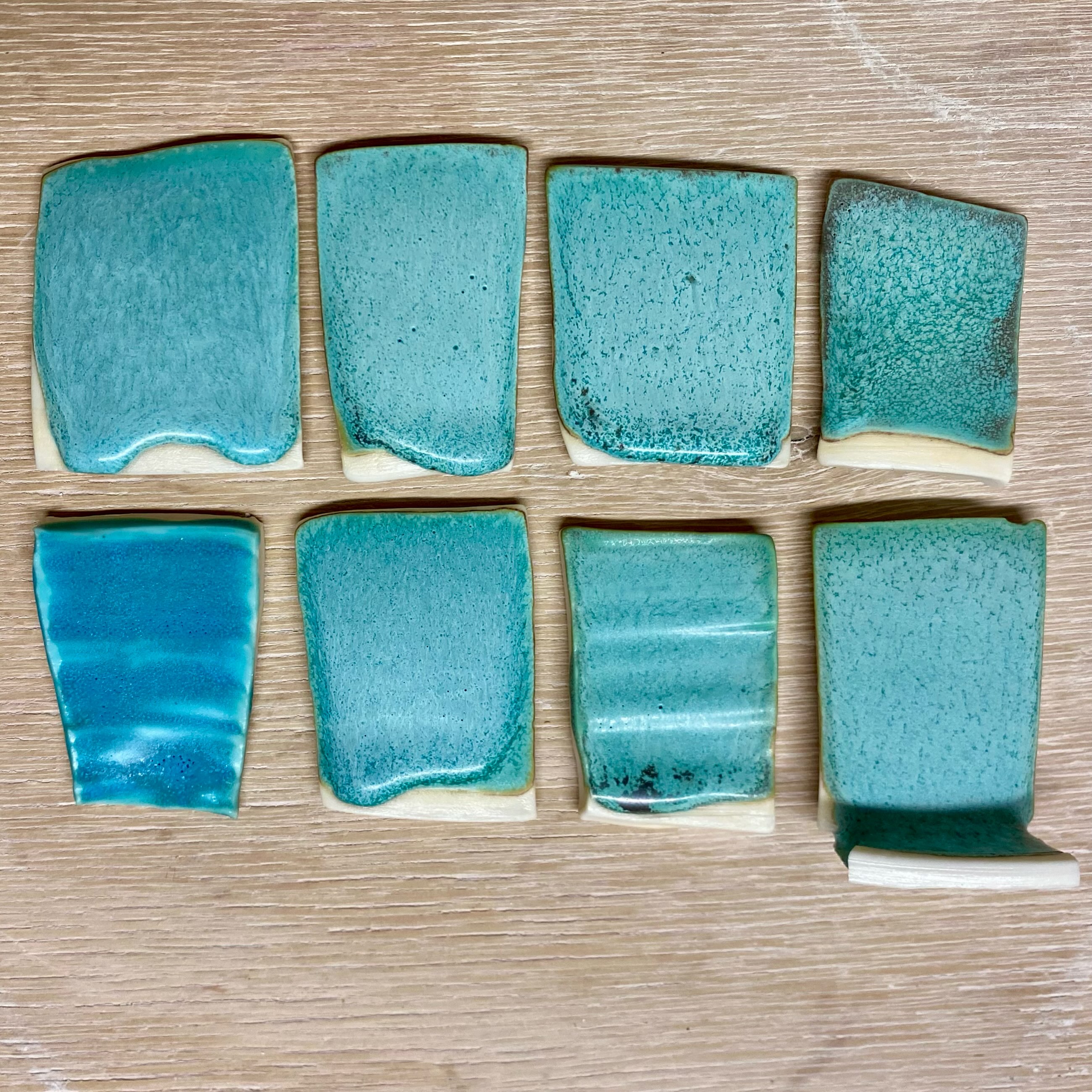 Strontium matt turquoise glaze tests. I added 5% then 10% kaolin, top row middle and far right, which made the glaze less runny.
I also tried it without lithium, bottom row far right and second from right, which didn’t seem to make much difference.