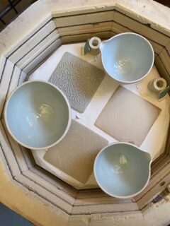 My kiln has an annoying habit of switching off before the firing has finished because the kiln controller gets too hot. This time it was windy weather and the door to the kiln shed was blown shut so the kiln switched off early and everything was underfired, in the first image. Some bowls also cracked. 

I refired and some plates were ok but around 80% cracked owing to the stresses of having glaze on one side. During firing, the fired porcelain and glaze both go through an increase in volume. If the thermal expansion is too different, and the pot wall is thin, the piece cracks.