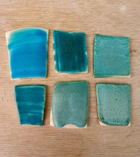 I’ve been trying to make this matt turquoise glaze less runny and more food safe.

Top left original strontium matt turquoise, middle, added more strontium and zinc oxide, right, added titanium dioxide.

Bottom left, latest batch of strontium matt turquoise, middle, added titanium dioxide, right added more kaolin 

Adding more strontium and zinc should make it more chemically stable, while adding kaolin makes it less runny. The titanium dioxide makes it a lighter colour.

You can find the recipes on Glazy.org
Strontium Matt turquoise and Katrina’s Dolphin Blue 🐬