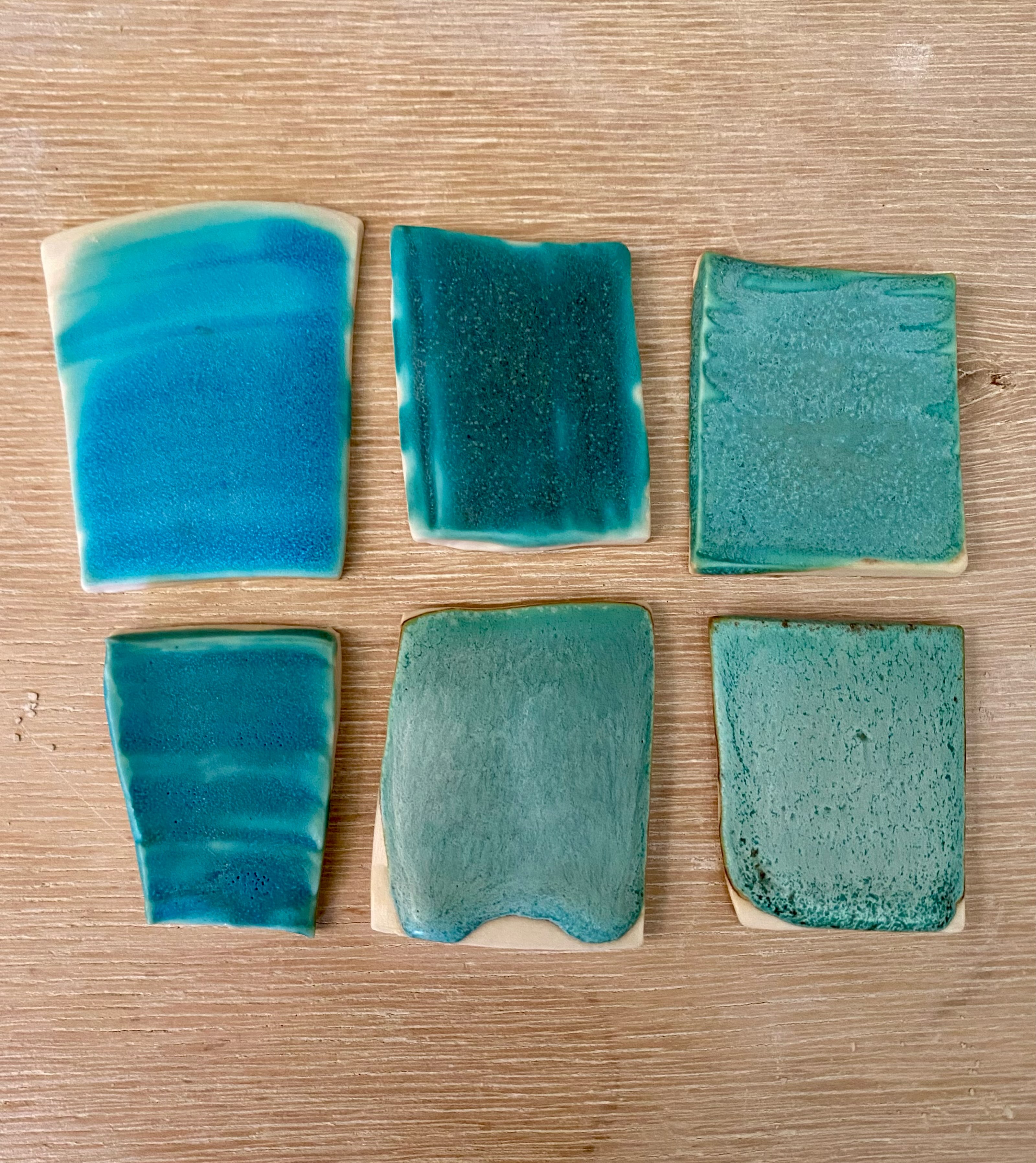 I’ve been trying to make this matt turquoise glaze less runny and more food safe.

Top left original strontium matt turquoise, middle, added more strontium and zinc oxide, right, added titanium dioxide.

Bottom left, latest batch of strontium matt turquoise, middle, added titanium dioxide, right added more kaolin 

Adding more strontium and zinc should make it more chemically stable, while adding kaolin makes it less runny. The titanium dioxide makes it a lighter colour.

You can find the recipes on Glazy.org
Strontium Matt turquoise and Katrina’s Dolphin Blue 🐬