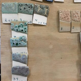 To make this lava glaze @guldagergaard_claytopia we started with the flux materials, nepheline syenite and strontium carbonate, added coarse 120 mesh silicon carbide and titanium dioxide to make craters, then added kaolin along the top row and silica down the middle column.

Large amounts of kaolin caused crawling and large amounts of silica reduced the colour, copper oxide in the first image and I think it may have been rutile in the second. Titanium dioxide reacts with iron in the clay body to produce rutile.