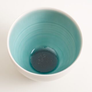 As well as soaking glaze tests in vinegar overnight to test for chemical durability, it's useful to have a look at the glaze chemistry on glazy.org. For calcium based glazes, a flux ratio close to 0.3:0.7 alkali metal to alkaline earth fluxes has been found to make the most durable glazes. For my glossy turquoise glaze I have found this to work in practice. But looking at the molecular level (grey silicon atoms, red oxygen, brown aluminium, purple sodium, green calcium) it could be the soda:alumina ratio that is more important. The aluminium has a charge Al3+ that needs to be balanced by a sodium Na+ so that it can be tied up in the glaze structure, which is mostly silica Si4+, so perhaps the soda should be equal to the alumina for a balanced, durable glaze. Is 1:1 R2O:Al2O3 more relevant for glaze durability than 0.3:0.7 R2O:RO? From my book Science for Potters.