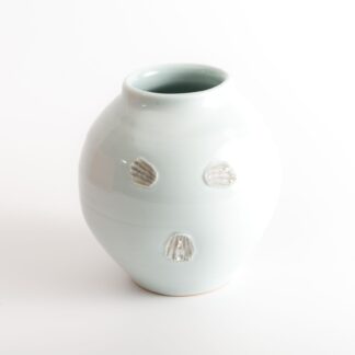 wood-fired porcelain vase with shell impressions
