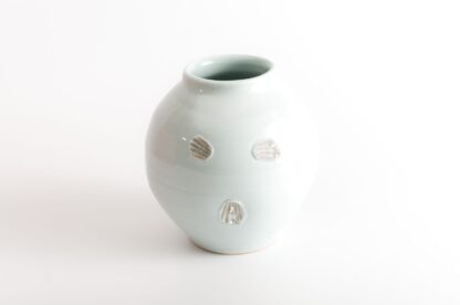 wood-fired porcelain vase with shell impressions