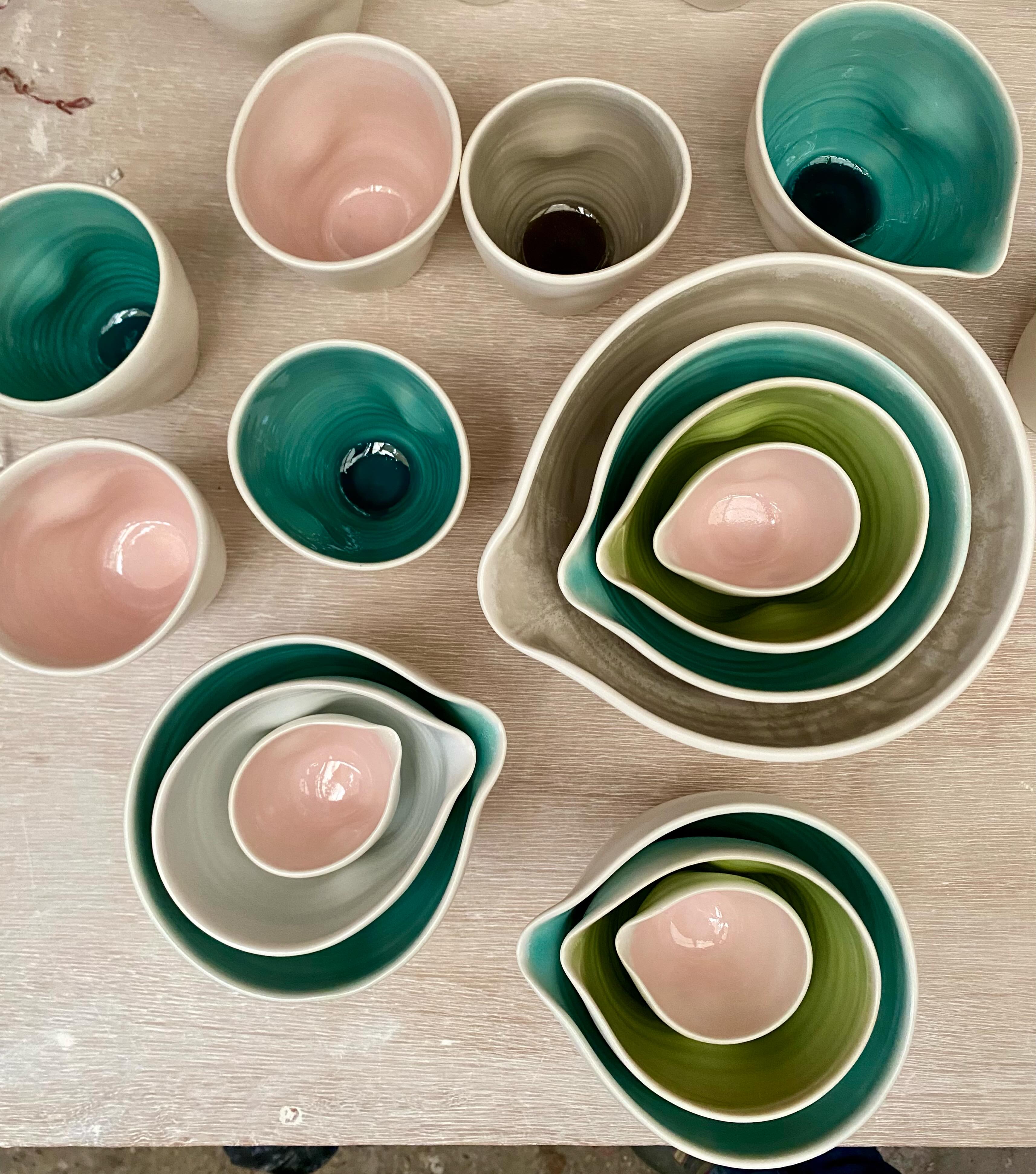 Dimpled cups and pouring bowls. I’ve been making this range of dimpled ware since 2005. They are made from porcelain thrown on the wheel with a satin matt glaze on the outside and glossy coloured glazes on the inside. 

I started with just pale pink and pale blue and later added other colours including grey, turquoise and lime green. I’m thinking of reducing the range of colours and including a celadon blue. Which is your favourite glaze colour?