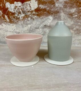 I often make setters, quickly thrown discs of clay that I place underneath porcelain pots to shrink with the pot during firing. These prevent warping. They are particularly useful for large bowls and essential for these Morandi lampshades without bases that I make for @handandeyestudio 

They can only be used once for this purpose but after that you can batt wash them and use them as ‘cookies’ to place underneath anything with a runny glaze