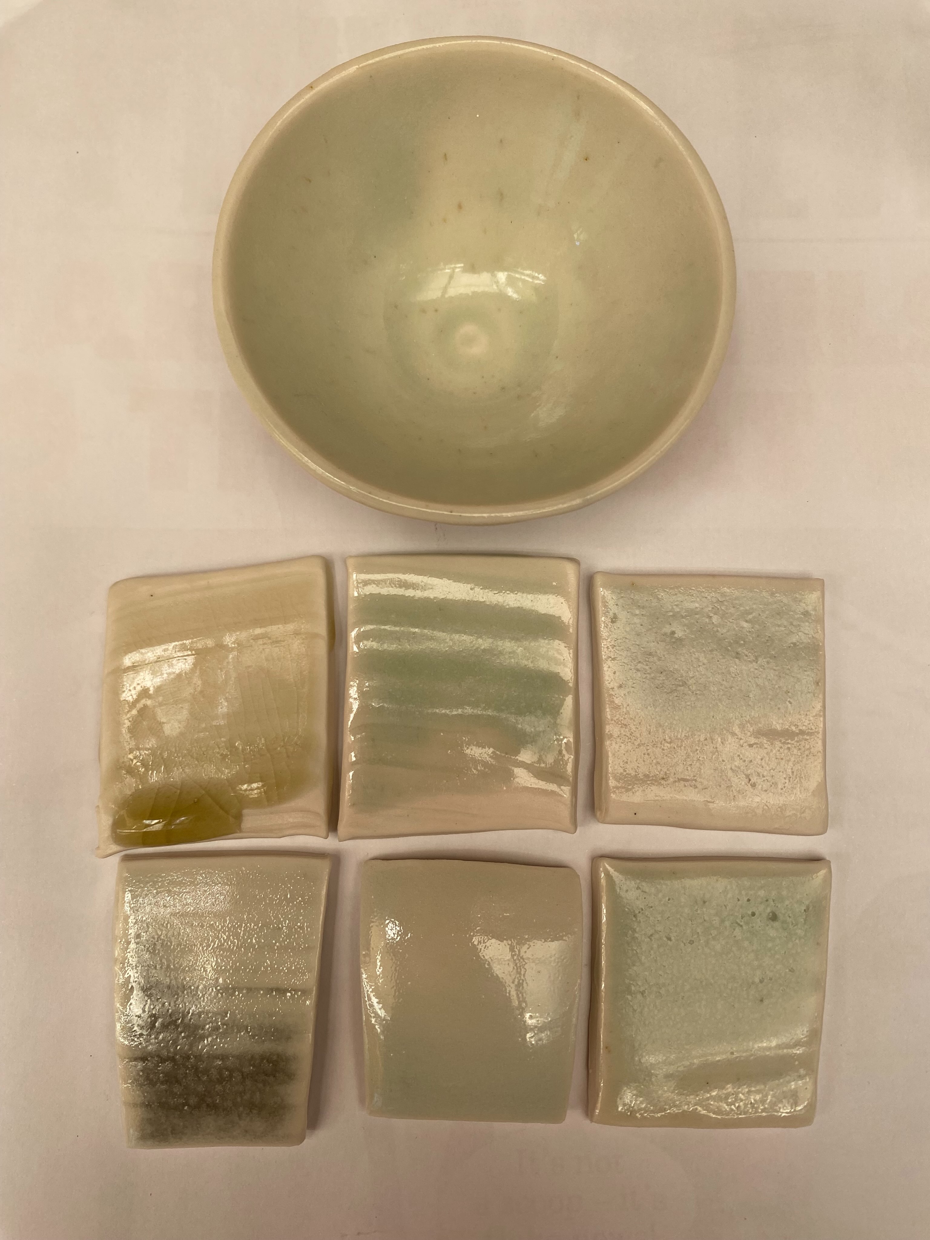 These are some of my electric kiln ash glazes and celadons, with the addition of 0.2-0.3% silicon carbide 1200 mesh and 1% tin oxide.

The silicon carbide reduces the iron oxide in the glaze from Fe3+ to Fe2+, changing the colour from yellow to blue-green. The tin oxide oxidises any remaining silicon carbide, changing it from black to colourless silica plus carbon dioxide gas.

The glaze needs to be fluid so that the gas can escape, otherwise you may end up with a lava glaze. Soaking at top temperature helps.